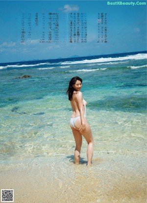 A naked woman is submerged in the water. 