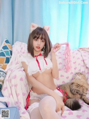 A woman in a white lingerie laying on a bed.