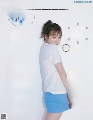 A woman in a white shirt is posing for a magazine.