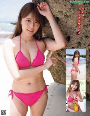 A woman in a bikini sitting on the beach.
