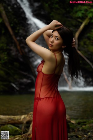 A woman in a red dress posing for a picture.