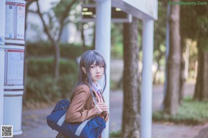 A woman in a school uniform is posing for a picture.