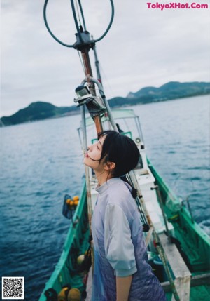 A woman sitting on a boat looking out the window.
