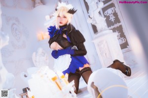 A woman in a maid outfit posing for a picture.