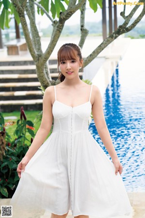 A woman in a wedding dress laying on a bed.