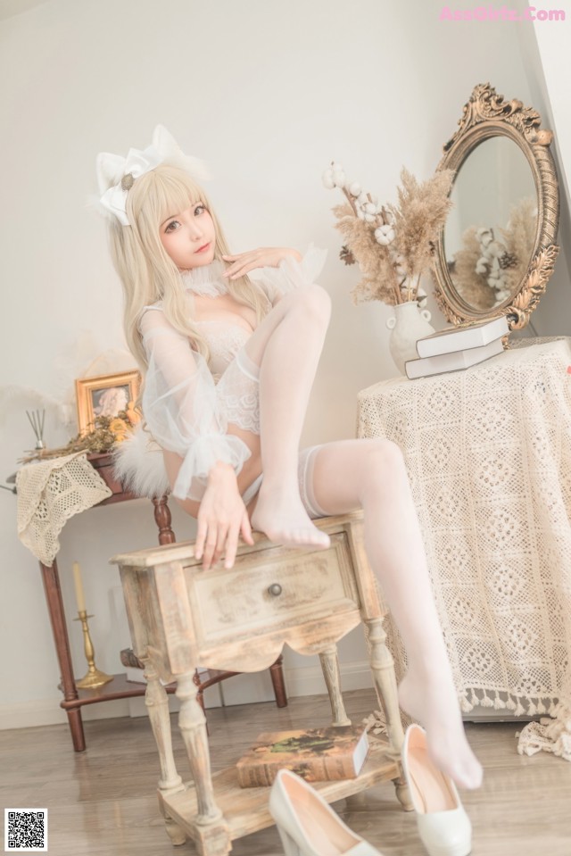 A woman sitting on top of a wooden table next to a mirror.