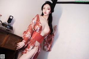 A woman in a kimono posing for the camera.