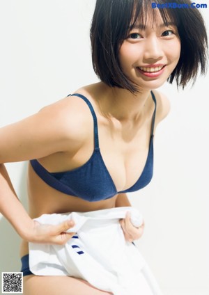 A woman in a white shirt and black tie.
