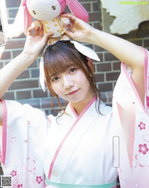 A woman in a brown and white outfit posing for a picture.