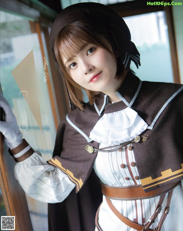 A woman in a brown and white outfit posing for a picture.