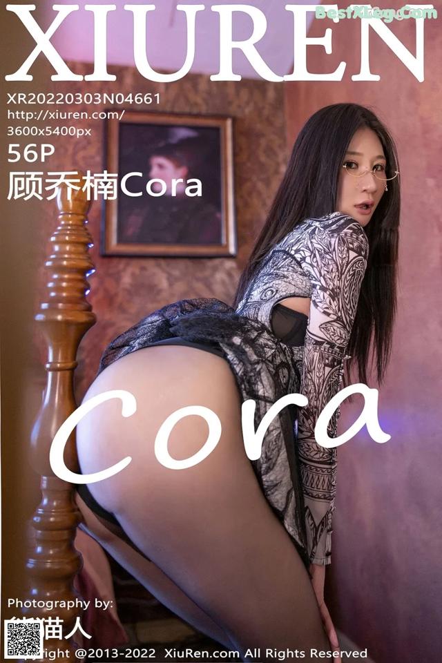 a woman in a black dress is posing on a bed