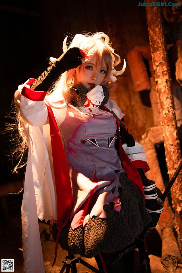 A woman dressed in a costume sitting on a chair.