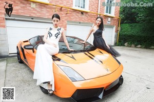 A woman sitting in the driver's seat of a sports car.