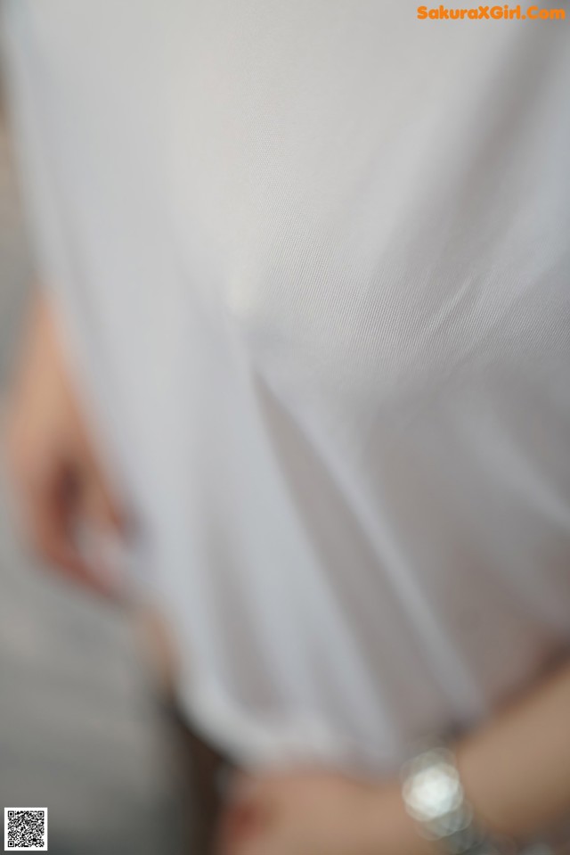 A close up of a person wearing a white shirt.