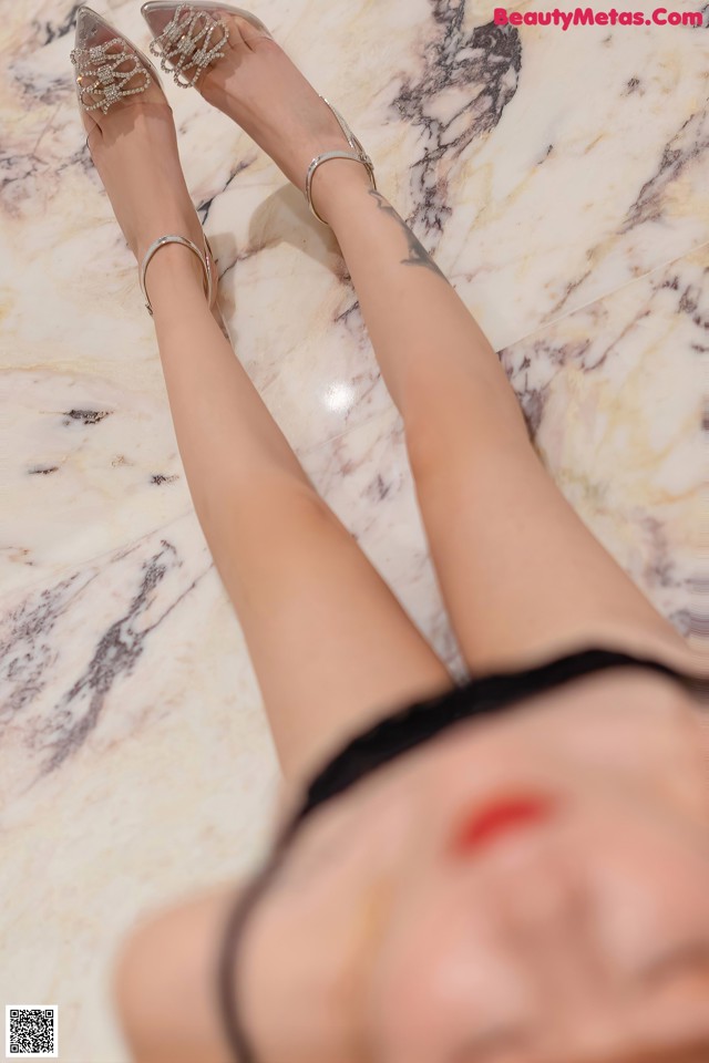 a woman laying on top of a marble floor